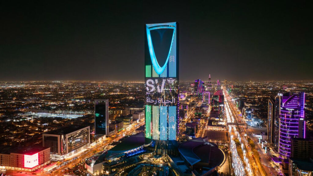 A skyscraper lit up with the letters S and V