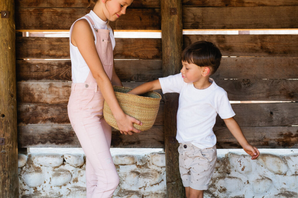 Children collecting eggs for breakfast