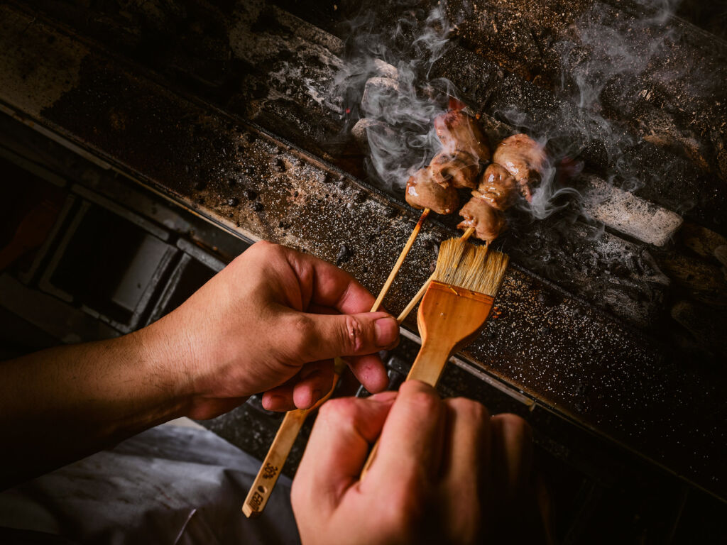 A brush being used to add extra flavour to a skewer