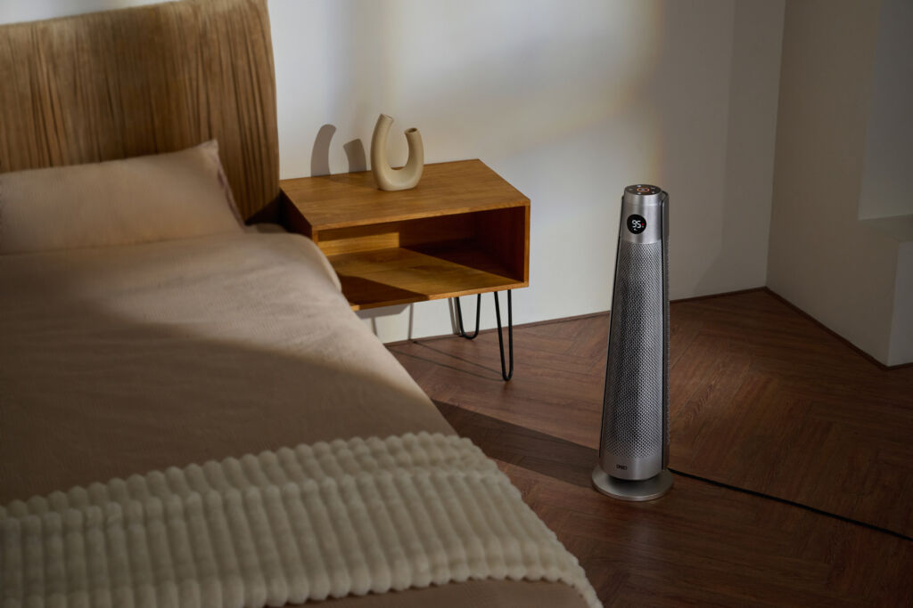 Product Review: A Chance to Warm to the New DREO Tower Heater 718 9 The device set beside a bed