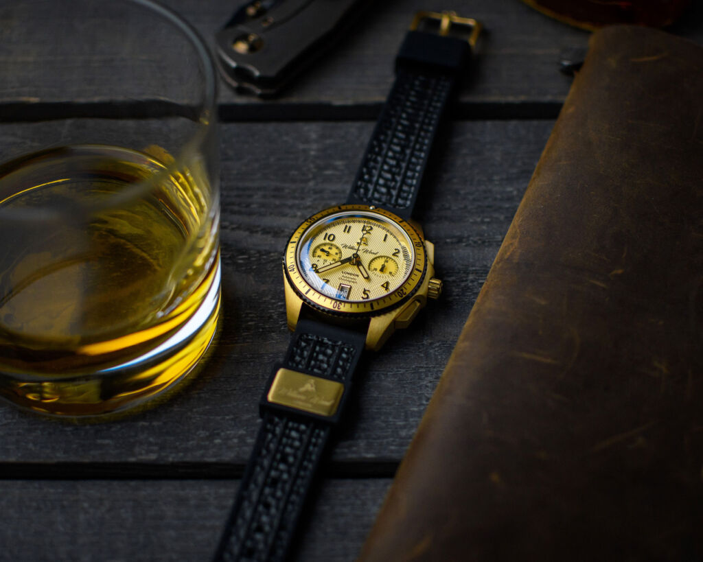 The timepiece next to a glass of whisky