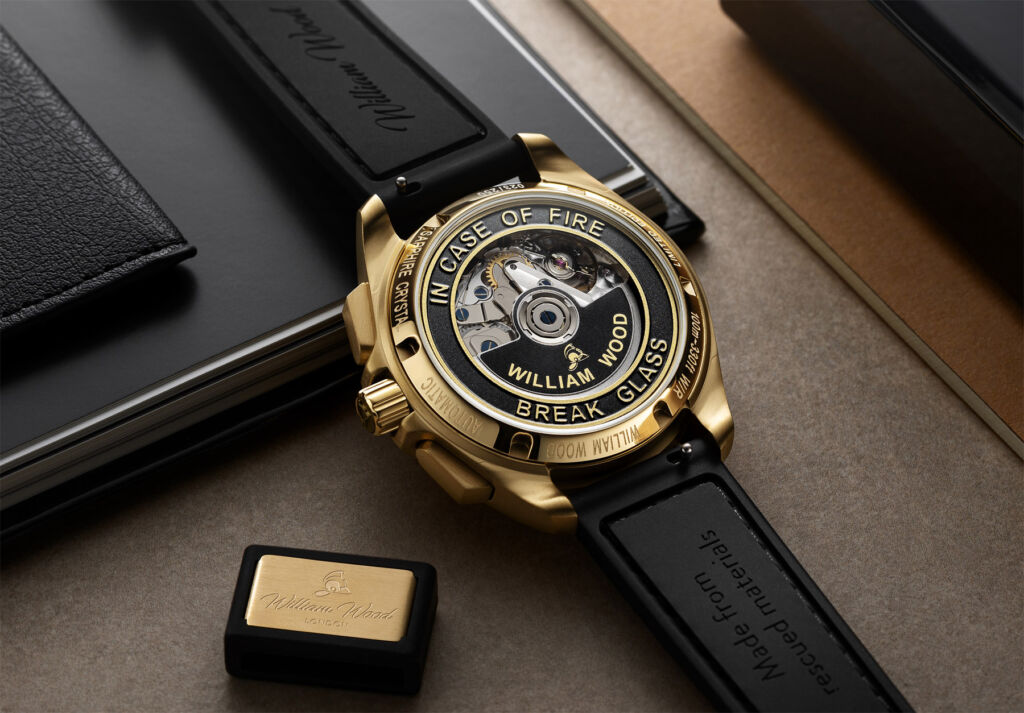 The rear of the time piece, with the embossed words "In case of fire break glass"