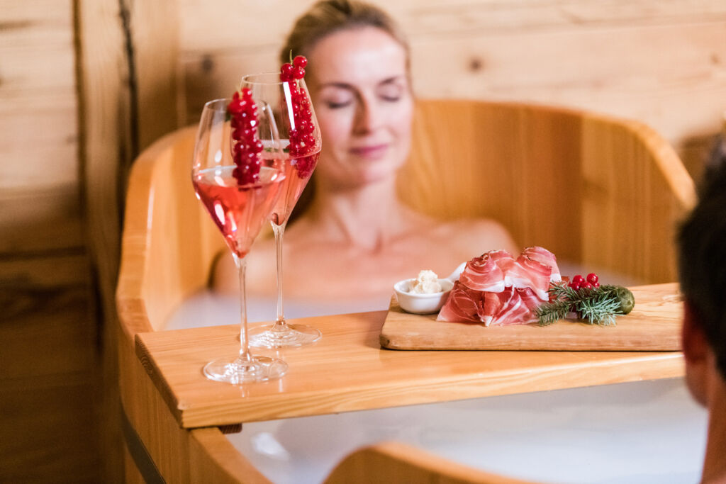 Why the Dolomites and Hotel Granbaita Are the Perfect Couples Retreat 14 A couple enjoying a hot bubble bath at the hotel