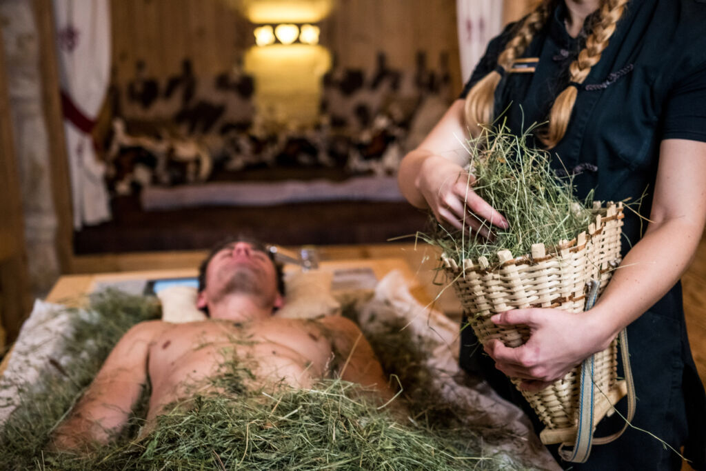 Why the Dolomites and Hotel Granbaita Are the Perfect Couples Retreat 15 A man lying down in the spa experiencing a nature-infused wellness treatment