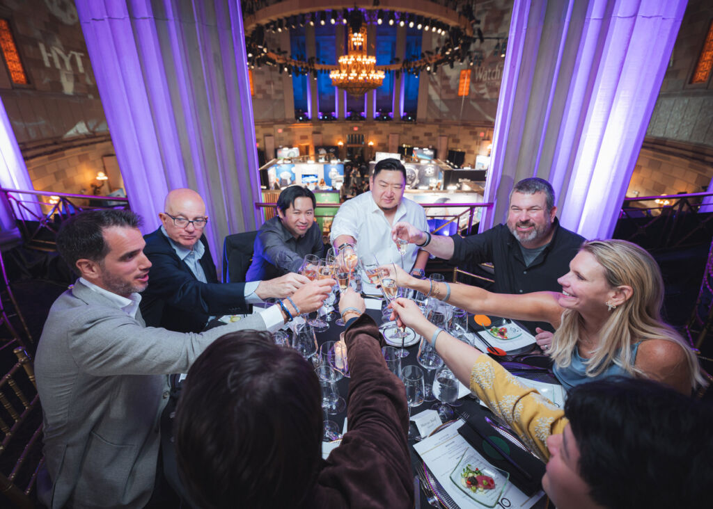 Guests making a toast at their dinner table