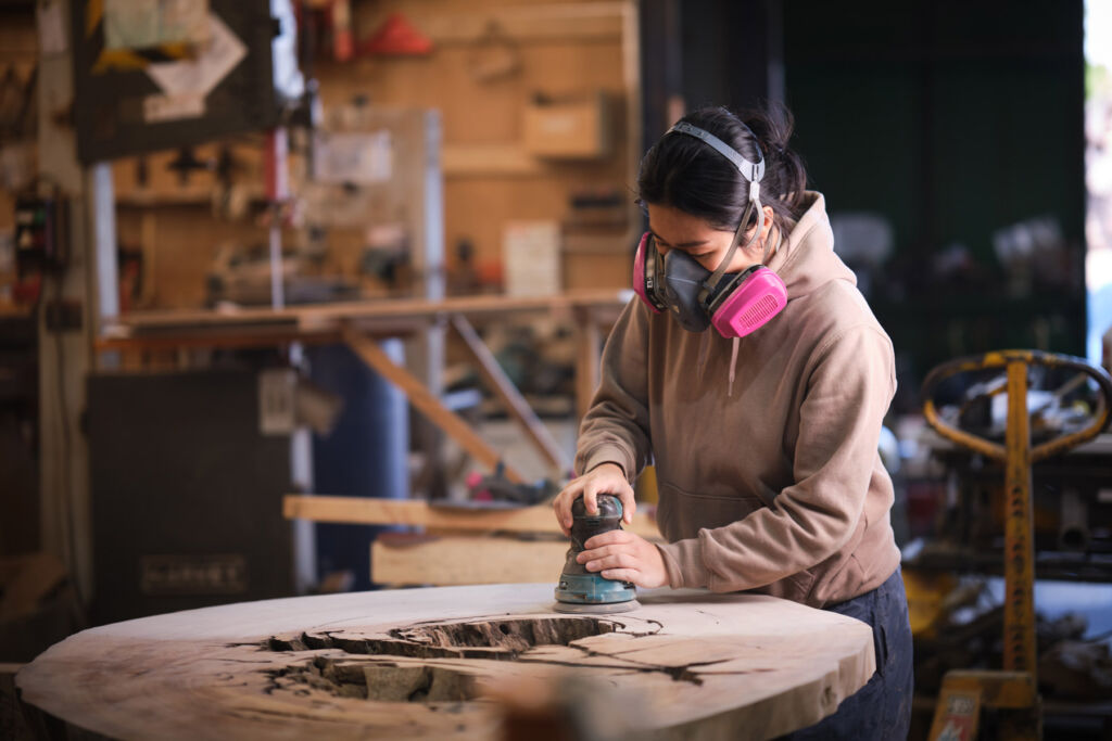 One of the artisans preparing reclaimed wood