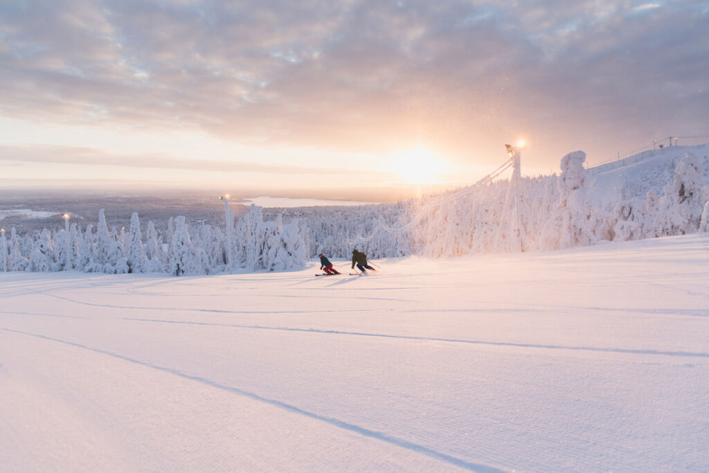 Skiers enjoying the lopes at sunset