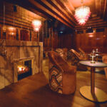 A rendering showing a lit fireplace in the lounge