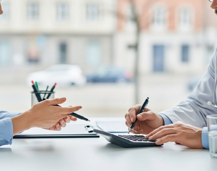 Low-Tax Welfare States Outperform Britain: Debunking the NHS Myth 1 Medical professionals keeping an eye on what a calculator is telling them